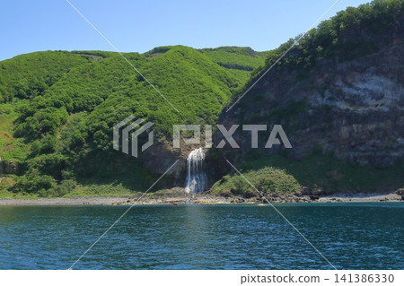 A view of Kamuiwakka Falls in Shiretoko, cascading down a cliff into the sea. A view of Kamuiwakka Falls in Shiretoko, cascading down a cliff into the sea. 141386330