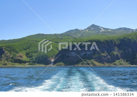 The beautiful scenery of the Shiretoko Peninsula visible beyond the ship's wake. The beautiful scenery of the Shiretoko Peninsula visible beyond the ship's wake. 141386334