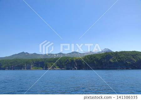 A spectacular view of the Shiretoko mountain range under a clear blue sky. A spectacular view of the Shiretoko mountain range under a clear blue sky. 141386335
