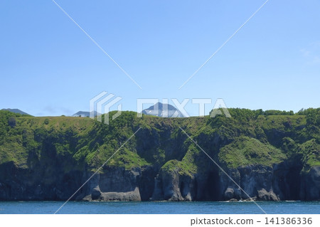 The summit of Mount Rausu as seen over the cliffs of the Shiretoko Peninsula. The summit of Mount Rausu as seen over the cliffs of the Shiretoko Peninsula. 141386336