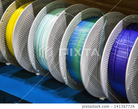 The brightly colored 3D coils are neatly laid out on the shelves in the workshop. The brightly colored 3D coils are neatly laid out on the shelves in the workshop. 141387726