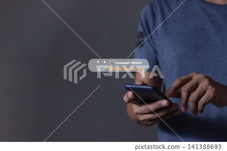 Customer Review, Young Man hand holding Smart Phone with five star to review and give 5 stars Customer Review, Young Man hand holding Smart Phone with five star to review and give 5 stars 141388693