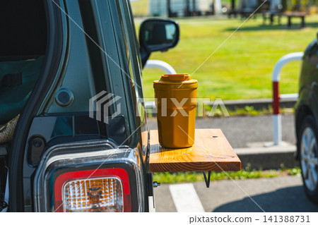A yellow tumbler placed on a DIY car magnetic table. A yellow tumbler placed on a DIY car magnetic table. 141388731