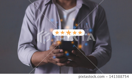 Customer Review, Young Man hand holding Smart Phone touching five star to review and give 5 stars  141388754