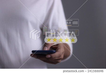 Customer Review, Young Man hand holding Smart Phone with five star to review and give 5 stars Customer Review, Young Man hand holding Smart Phone with five star to review and give 5 stars 141388846