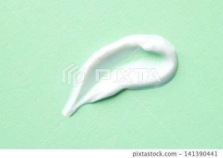 White skincare cream smear on mint background for beauty product texture and moisturizer sample 141390441