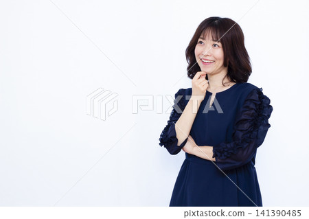 A businesswoman thinking with a smile A businesswoman thinking with a smile 141390485