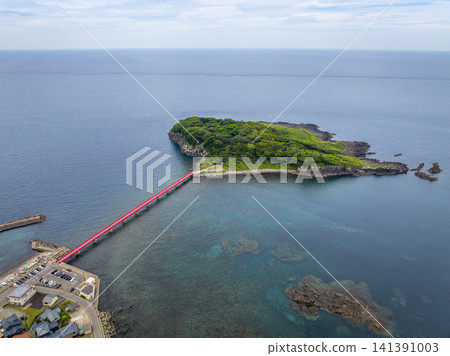 Drone aerial view of Oshima Island and the red Oshima Bridge in Mikuni-cho, Sakai City, Fukui Prefecture, overlooking the Sea of Japan. Drone aerial view of Oshima Island and the red Oshima Bridge in Mikuni-cho, Sakai City, Fukui Prefecture, overlooking the Sea of Japan. 141391003