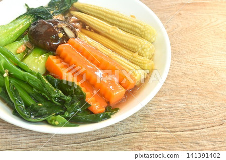 fried mixed vegetable dressing sesame oil and soy sauce with chop garlic on plate fried mixed vegetable dressing sesame oil and soy sauce with chop garlic on plate 141391402