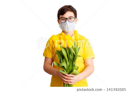 a boy in medical mask on his face hold a bouquet tulips a boy in medical mask on his face hold a bouquet tulips 141392085