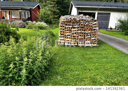 Woodpile of Birch Firewood on Lawn in Porvoo, Finland. Woodpile of Birch Firewood on Lawn in Porvoo, Finland. 141392361