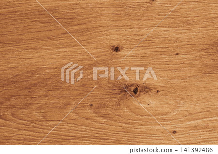 Horizontal close up overhead view of a warm golden brown wood texture with natural oak grain rings and rustic timber knots for vintage background design Horizontal close up overhead view of a warm golden brown wood texture with natural oak grain rings and rustic timber knots for vintage background design 141392486