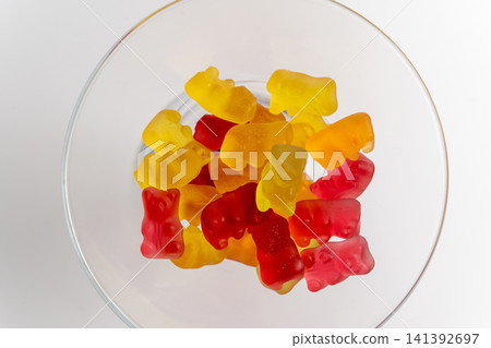 Marmalade bears are arranged in a clear bowl on a plain surface Marmalade bears are arranged in a clear bowl on a plain surface 141392697