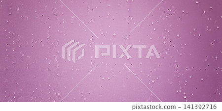 Water droplets on pink surface create a colorful and simple design 141392716