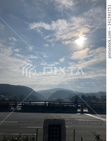 A dramatic view of the bridge and mountains bathed in clouds and sunlight. A dramatic view of the bridge and mountains bathed in clouds and sunlight. 141393751