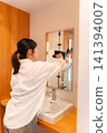 Woman cleaning the wash basin 141394007
