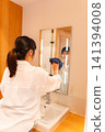 Woman cleaning the wash basin 141394008