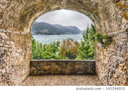 Picturesque Lake Como View Through an Ancient Stone Archway Picturesque Lake Como View Through an Ancient Stone Archway 141394033