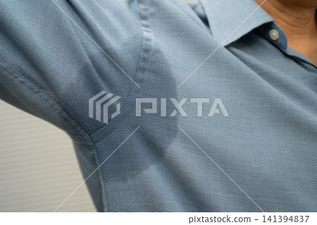 Man with sweaty arm pit on shirt when working in office, Hyperhidrosis sweating. Man with sweaty arm pit on shirt when working in office, Hyperhidrosis sweating. 141394837