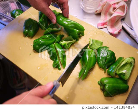 A woman's hands cutting a bell pepper A woman's hands cutting a bell pepper 141394854