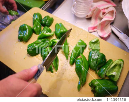 A woman's hands cutting a bell pepper A woman's hands cutting a bell pepper 141394856