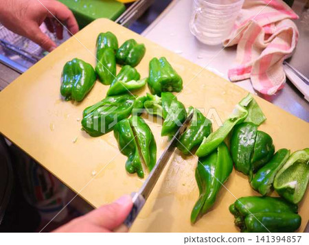 A woman's hands cutting a bell pepper A woman's hands cutting a bell pepper 141394857