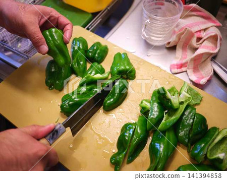 A woman's hands cutting a bell pepper A woman's hands cutting a bell pepper 141394858