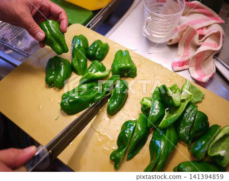 A woman's hands cutting a bell pepper A woman's hands cutting a bell pepper 141394859