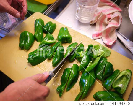 A woman's hands cutting a bell pepper A woman's hands cutting a bell pepper 141394860