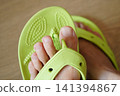 Close-up of a plastic sandal with a broken thong. 141394867