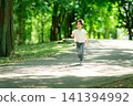 A boy who runs in a fresh green park 141394992
