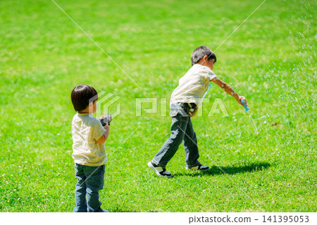 Brothers playing in the park Brothers playing in the park 141395053