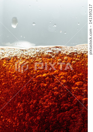 Sparkling cola is poured into a glass. 141395217