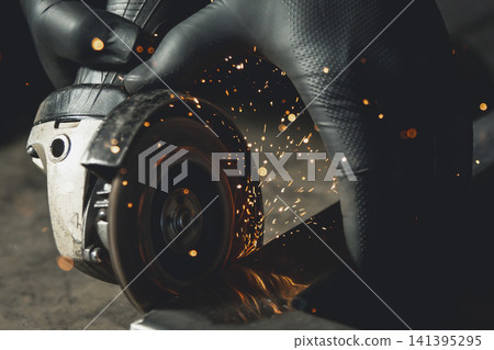 A close-up shot of a grinder blade and sparks during metalworking. A close-up shot of a grinder blade and sparks during metalworking. 141395295