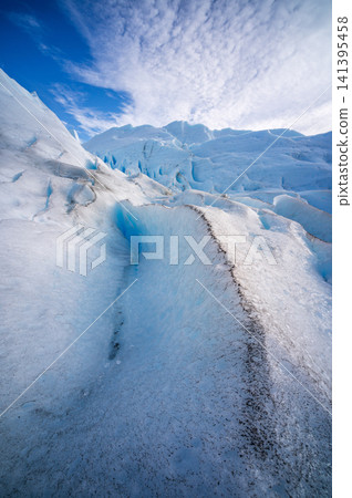 Perito moreno glacier landscape showing climate change impact and serene atmosphere with awe inspiring blue ice formation reflecting majestic frozen nature environment bright clear sky outdoor Perito moreno glacier landscape showing climate change impact and serene atmosphere with awe inspiring blue ice formation reflecting majestic frozen nature environment bright clear sky outdoor 141395458