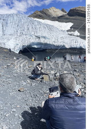 Man flying drone at Pastoruri glacier in Peru Man flying drone at Pastoruri glacier in Peru 141395486