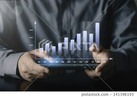Businessman using smartphone with glowing bar chart showing monthly annual growth month. Concept of mobile data analytics, financial performance tracking and business success. Businessman using smartphone with glowing bar chart showing monthly annual growth month. Concept of mobile data analytics, financial performance tracking and business success. 141396193