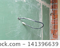 Exposed electrical wiring on gypsum wall during home renovation 141396639