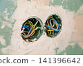 Exposed electrical wiring inside unfinished gypsum wall background 141396642