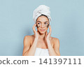 Relaxed woman enjoying spa treatment with eye masks 141397111