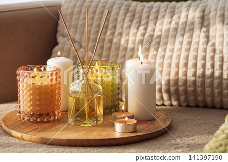Relaxing home decor with candles and reed diffuser for wellness Relaxing home decor with candles and reed diffuser for wellness 141397190