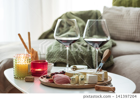 Romantic evening with red wine, cheese, and charcuterie board 141397204