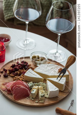 Wine and cheese board pairing for cozy evening Wine and cheese board pairing for cozy evening 141397205