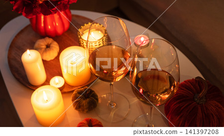 Cozy autumn evening with wine and candlelight ambiance Cozy autumn evening with wine and candlelight ambiance 141397208