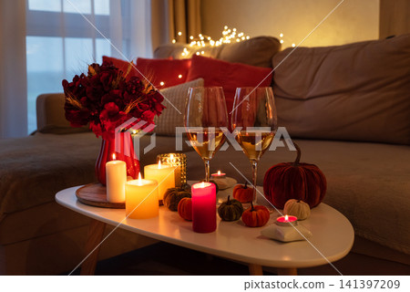 Autumn evening creating cozy romantic atmosphere with candles Autumn evening creating cozy romantic atmosphere with candles 141397209