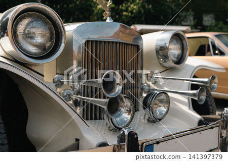 Chrome Horns and Headlights on Neoclassic Luxury Car Chrome Horns and Headlights on Neoclassic Luxury Car 141397379