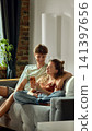 Young couple checking online furniture order on smartphone 141397656