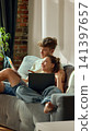 Young couple planning apartment color scheme with laptops and swatches 141397657