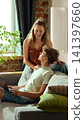 Young couple discussing online furniture purchase on laptop at home 141397660