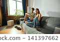 Young couple choosing home decor online together on smartphone 141397662